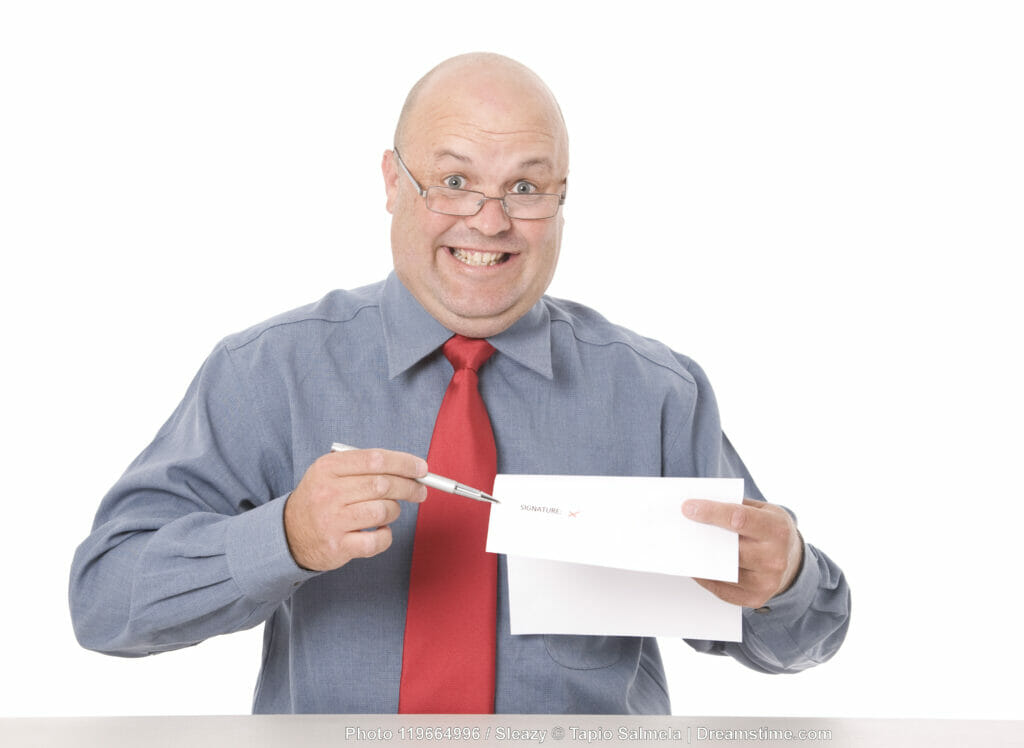 Picture of a grinning car salesman trying to get a buyer to sign a contract